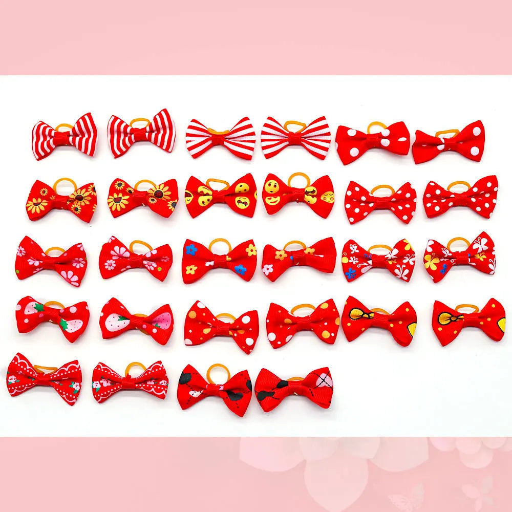 A collection of red and white pet hair bows with gentle rubber bands in various patterns.