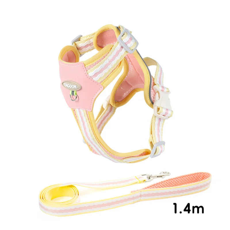 A pink and white adjustable dog harness with reflective straps is shown against a white background.