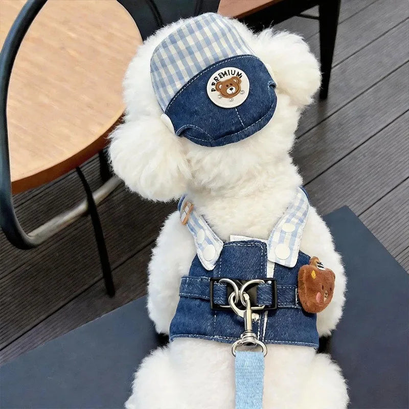 A fluffy white cartoon dog wearing a blue and white plaid harness vest with a leather tag and metal clasp.