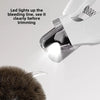 A close-up of a white pet nail trimmer illuminating a bleeding line on a pet's nail.