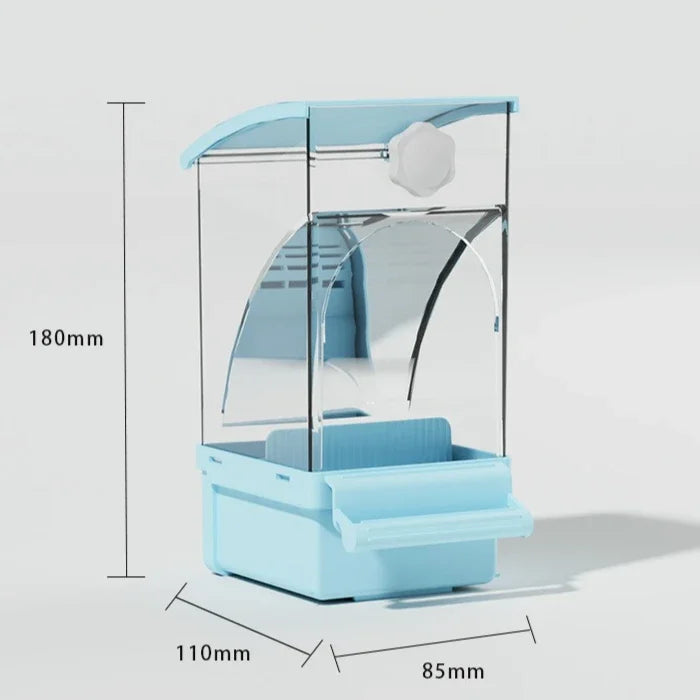 A light blue automatic parrot feeder with a clear dome and a separate husk compartment.
