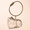 A clear silicone cat figurine keychain with a braided cord and metal clasp.