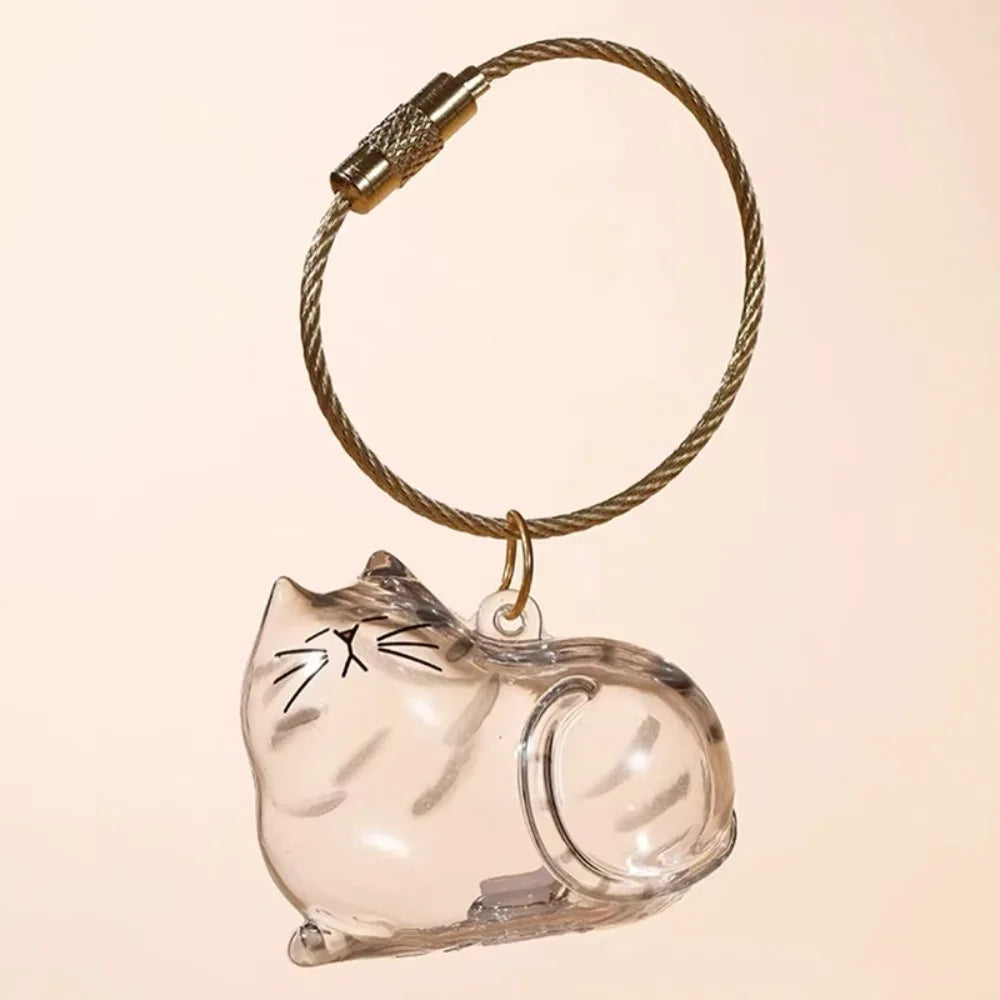 A clear silicone cat figurine keychain with a braided cord and metal clasp.