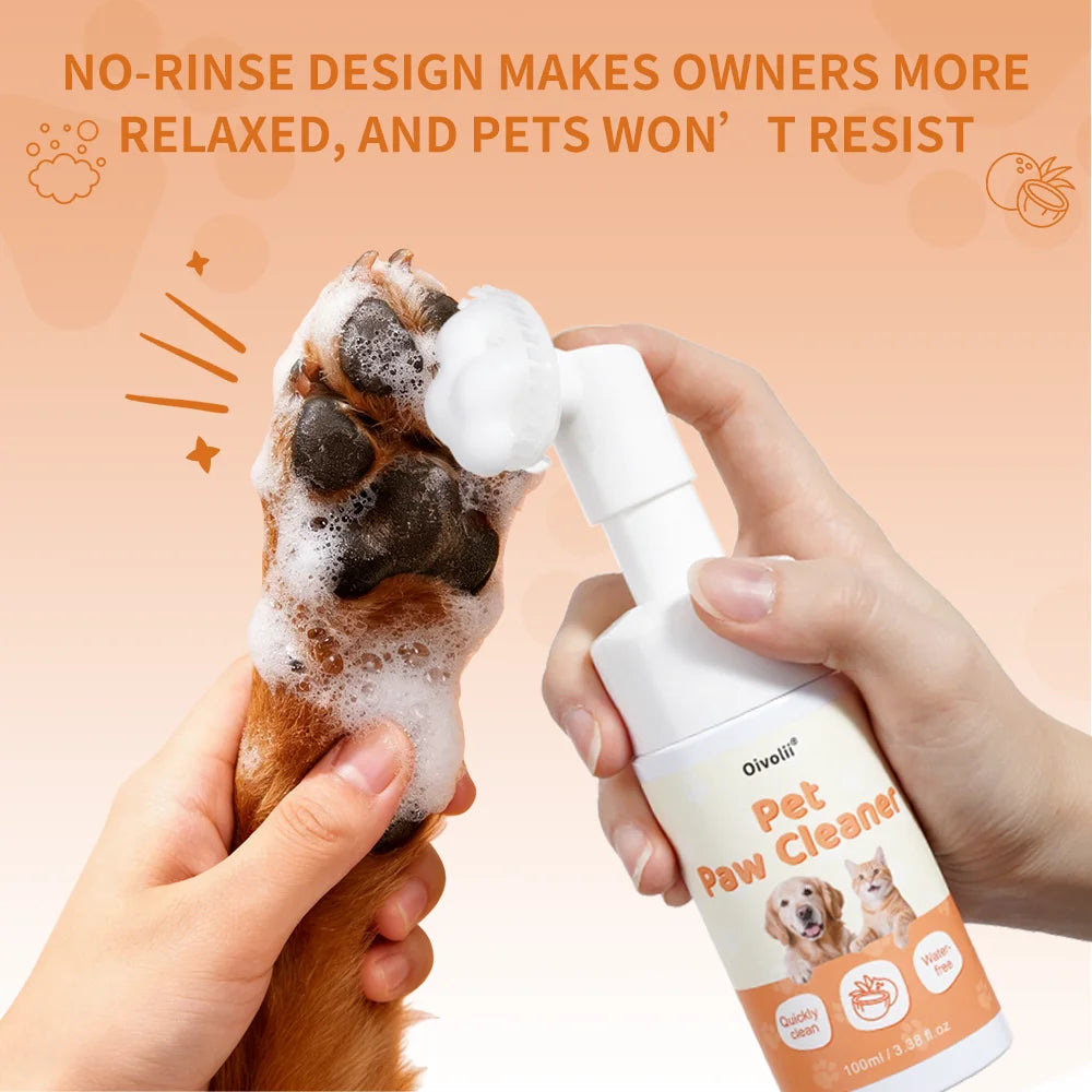 Hands are cleaning a dog's paw with an Oivoli Pet Paw Cleaner, demonstrating a no-rinse design.