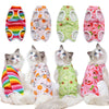 A collection of colorful recovery vests for cats, featuring rainbow stripes, floral patterns, and various bright colors.