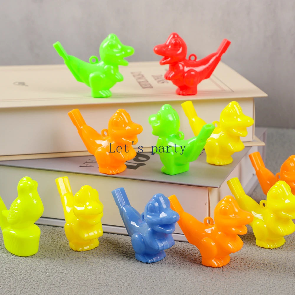 A collection of ten colorful bird and dinosaur water whistles in various bright colors arranged on a stack of books.