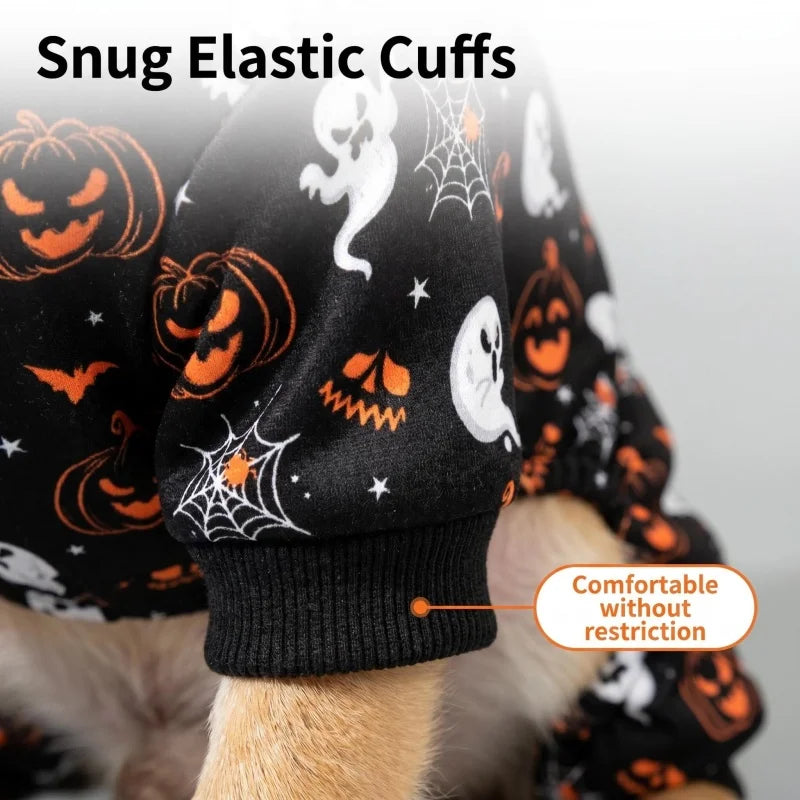 A close-up of a dog wearing black and orange Halloween costume pajamas with snug elastic cuffs.