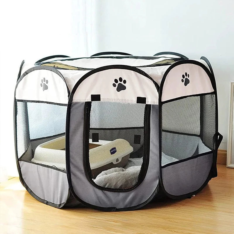 A folding octagonal pet cage for dogs with a mesh enclosure and soft bedding inside.
