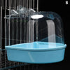 A clear plastic hanging bird bath for parakeets is suspended in a wire cage.