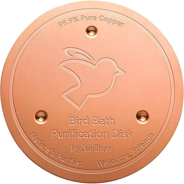 A round, copper purification disk for a bird bath featuring an engraved dove design.