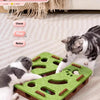 A tabby cat plays with an interactive puzzle toy designed for indoor cat play.