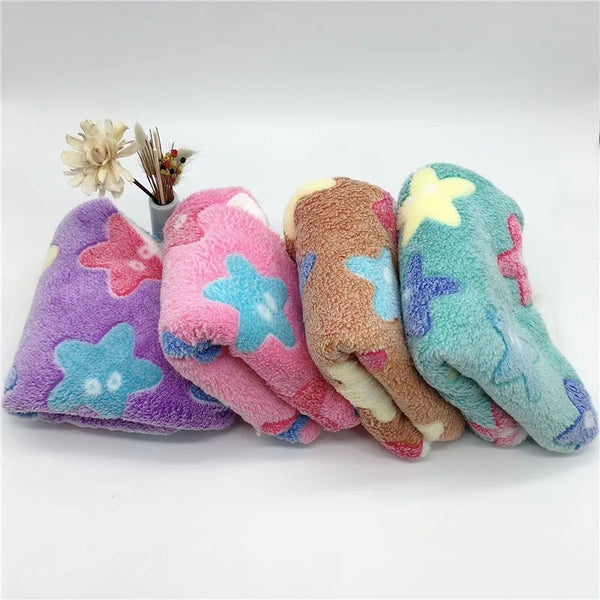 A collection of four fuzzy fleece hamster hammock beds in purple, pink, brown, and teal.
