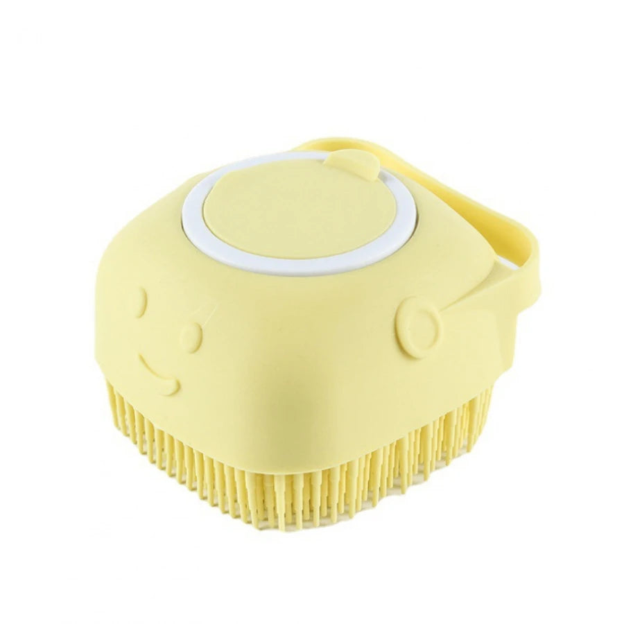 A yellow gentle dog bath brush with a shampoo dispenser is shown from above.
