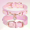 Pink leather dog collar with a gold-tone heart rhinestone charm