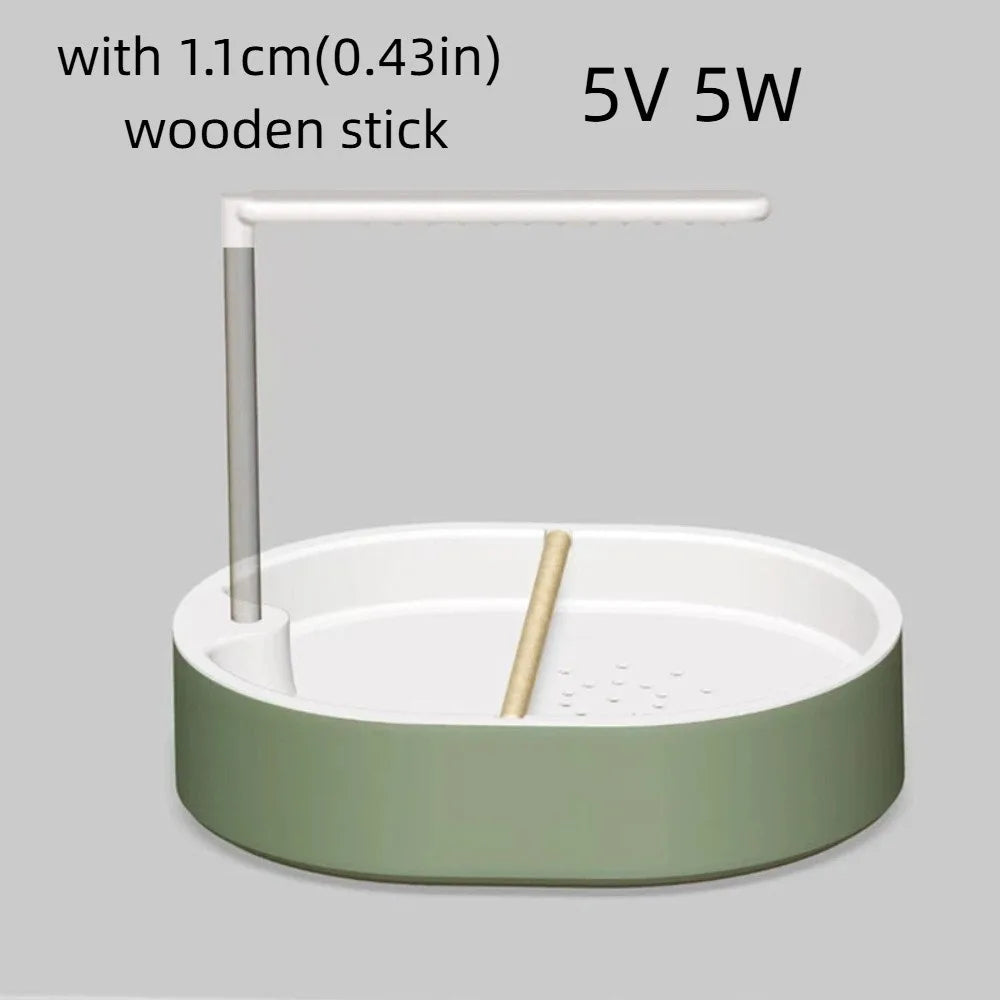 A white automatic bird bathtub with a green base and a white resting stick.