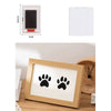 A wooden photo frame displaying black paw prints, suitable for keepsake or craft projects.