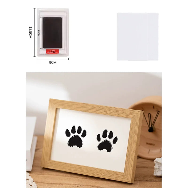 A wooden photo frame displaying black paw prints, suitable for keepsake or craft projects.