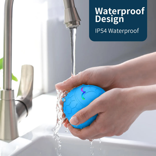 A hand holds a blue electronic pet ball as water flows from a faucet into the sink.