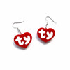 Pair of red acrylic heart drop earrings with the initials TY