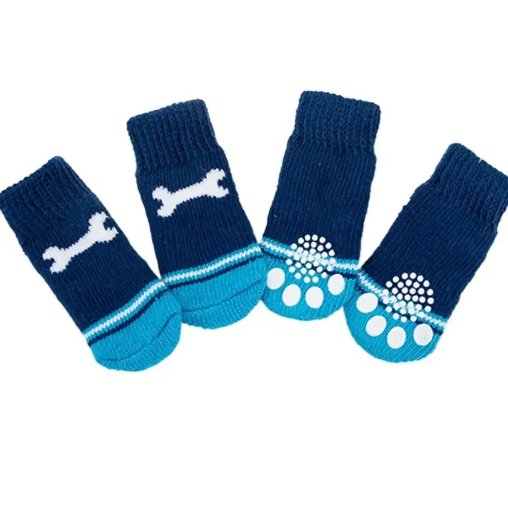 A pack of four navy blue anti-slip pet socks for dog and cat protection