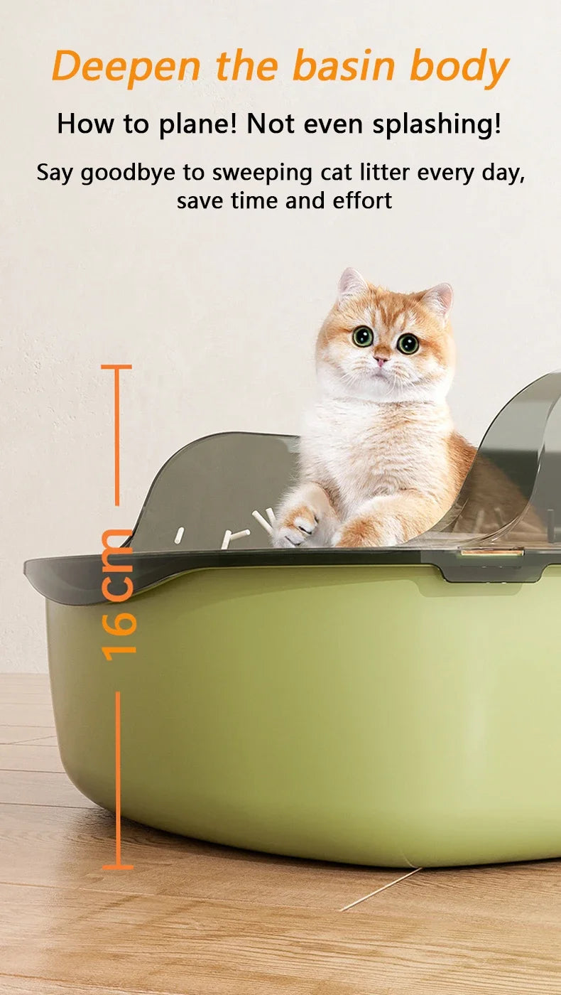 A fluffy orange cat sits inside a light green semi-enclosed litter box with high sides and a splash guard.