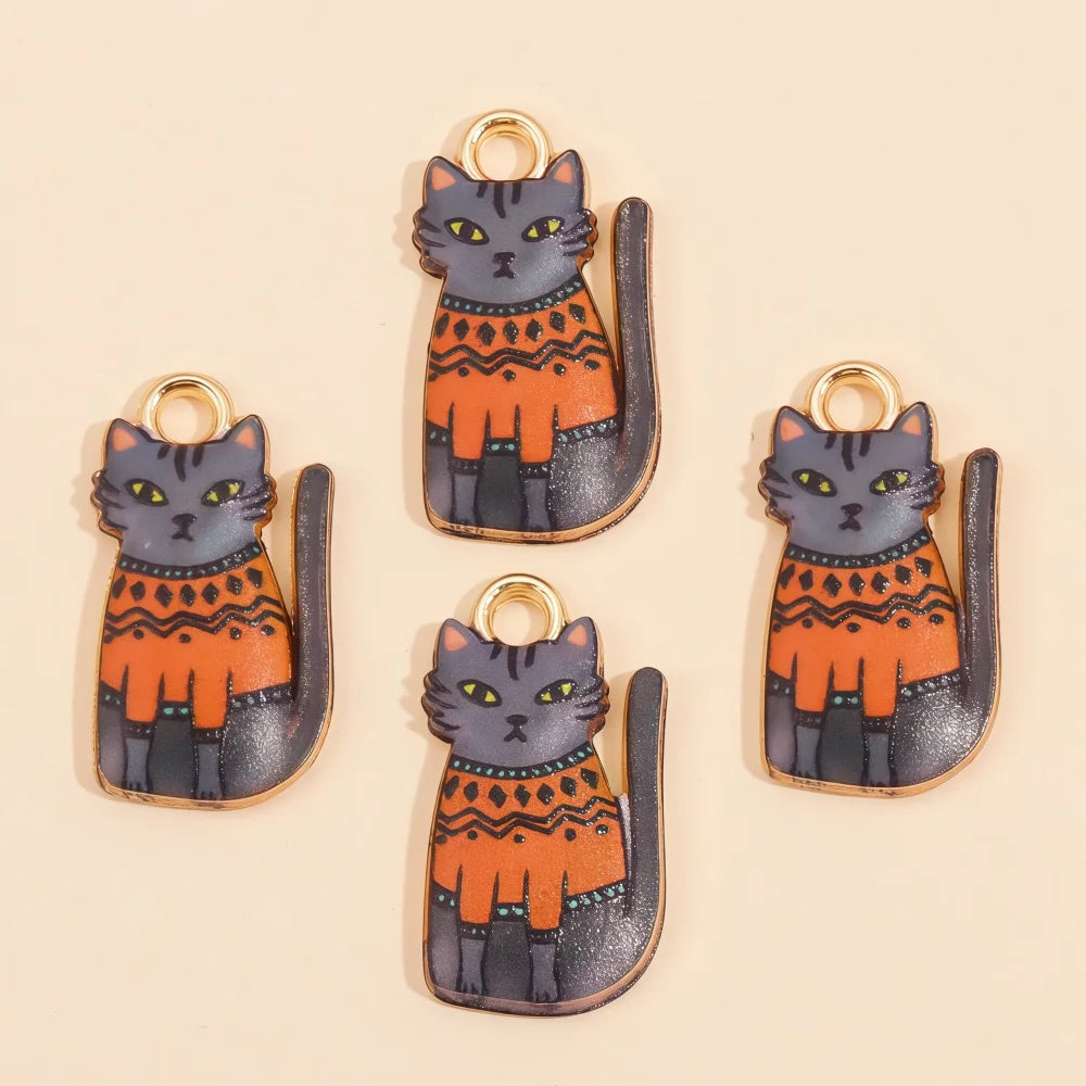 A set of four colorful cat and animal pendant charms in orange, gray, and black for jewelry making