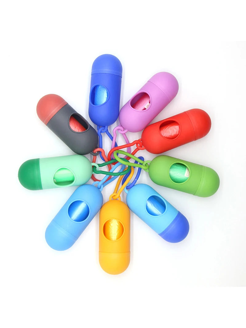 A collection of colorful capsule-shaped dog poop bag dispensers with carabiner clips.