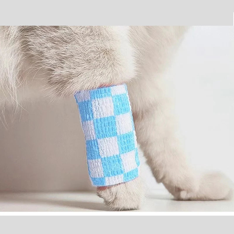 A light-colored dog's leg is shown wearing a blue and white checkered anti-dirt legging.