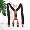 A pair of adjustable clip-on suspenders for kids in black and brown leather.