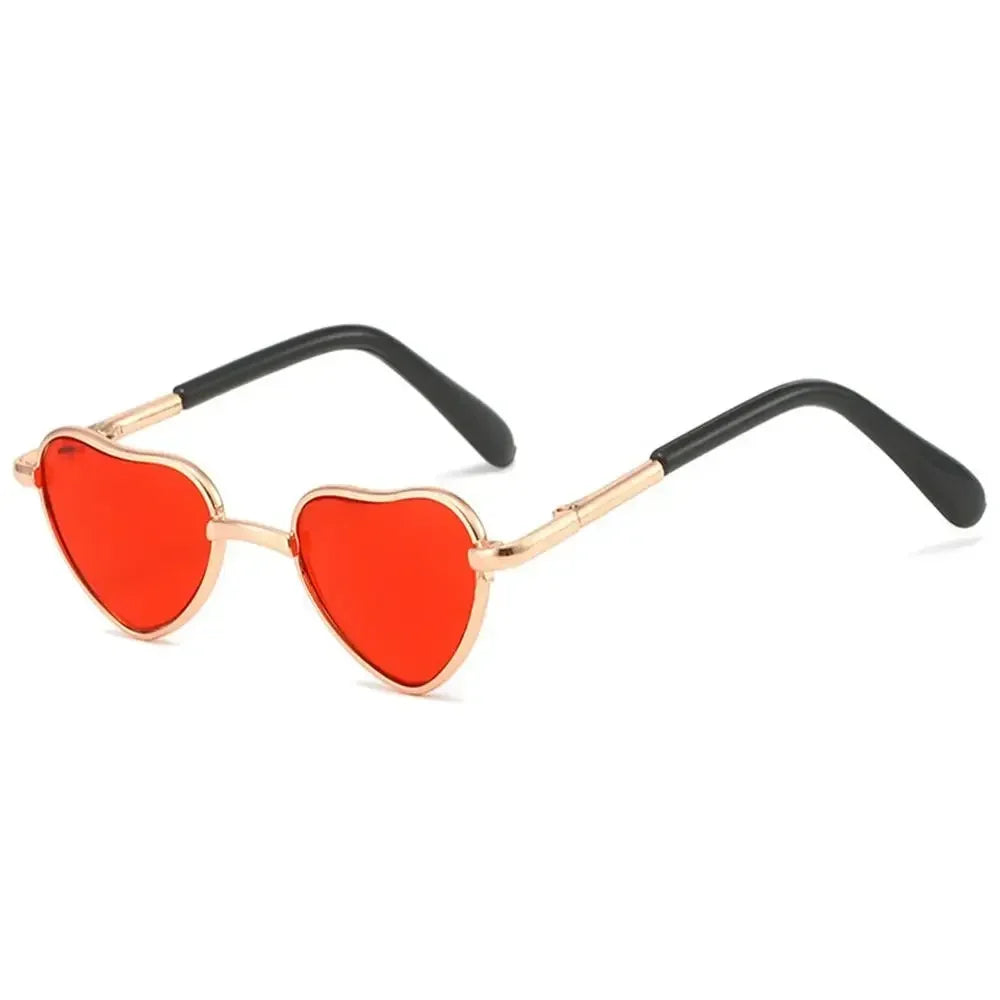 Red heart-shaped pet sunglasses for cats and dogs with gold and black frames