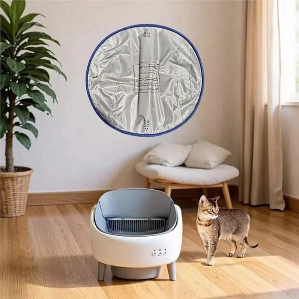 A circular silver and blue replacement liner for a self-cleaning litter box hangs on a wall.