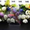Precision Hama beads tweezers kit with various colored beads and green leaves