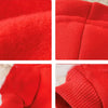 Close-up view of a bright red plush coat for small pets, showing texture and stitching details.