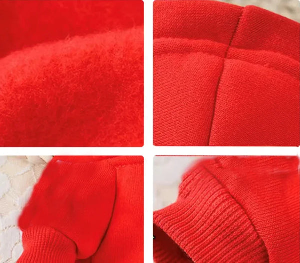 Close-up view of a bright red plush coat for small pets, showing texture and stitching details.