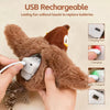 A hand is holding a brown teddy bear toy with a charging port, demonstrating the USB rechargeable feature.
