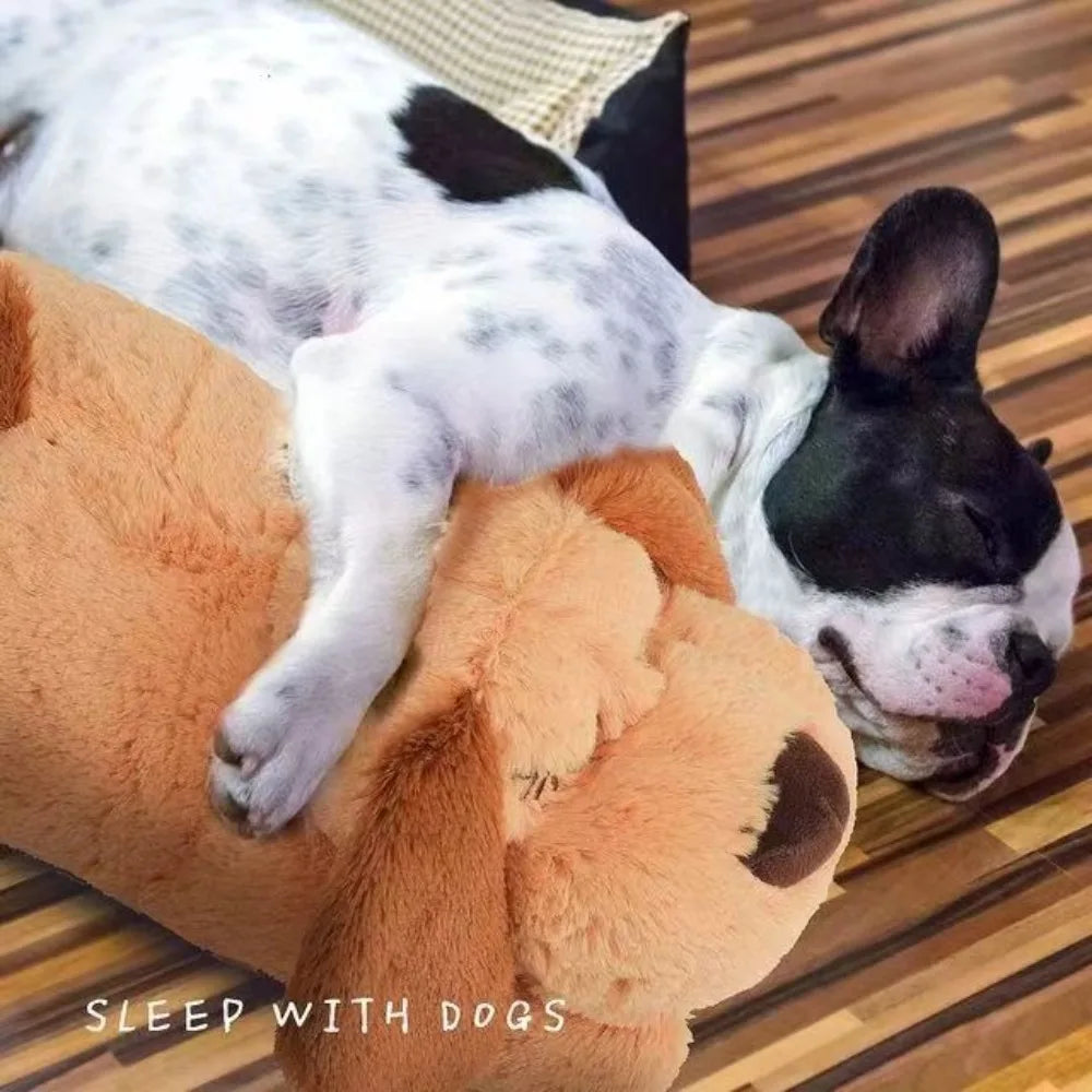 A white and black dog is resting on a large, tan plush comfort toy.