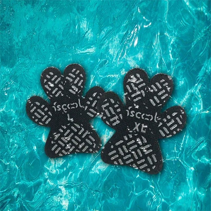 Black anti-slip paw protectors for dogs floating in clear blue water
