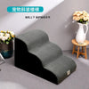 A gray washable non-slip pet stair ramp is shown resting on a light gray floor next to a white vase and wooden stool.