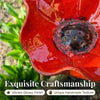 A close-up of a bright red, handcrafted ceramic bowl with a textured surface.