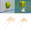 A pair of white fruit forks used for a bird feeding rack.