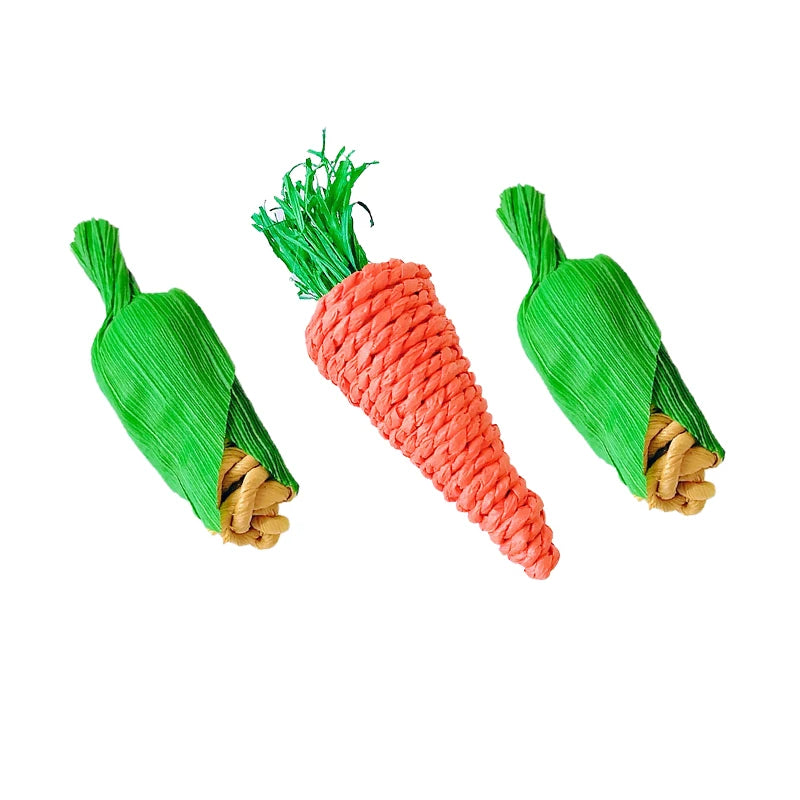 A handwoven natural vine bird and pet swing toy with bright green leaves and orange-red fibers.