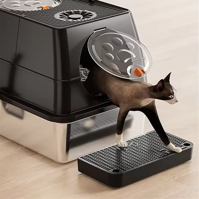A black cat litter box ramp step with a filter tray is shown on a wooden floor.