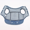 A light blue denim dog jacket with D-ring leash attachment.