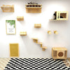Wall-mounted wooden cat climbing shelves with a hammock and scratching post mounted on a white wall.