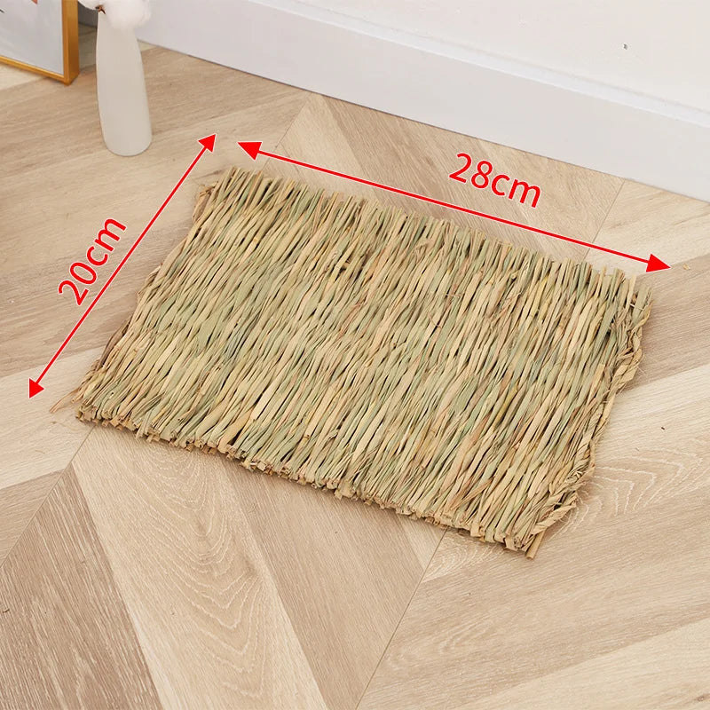 A rectangular mat woven from natural straw placed on a light wood floor.