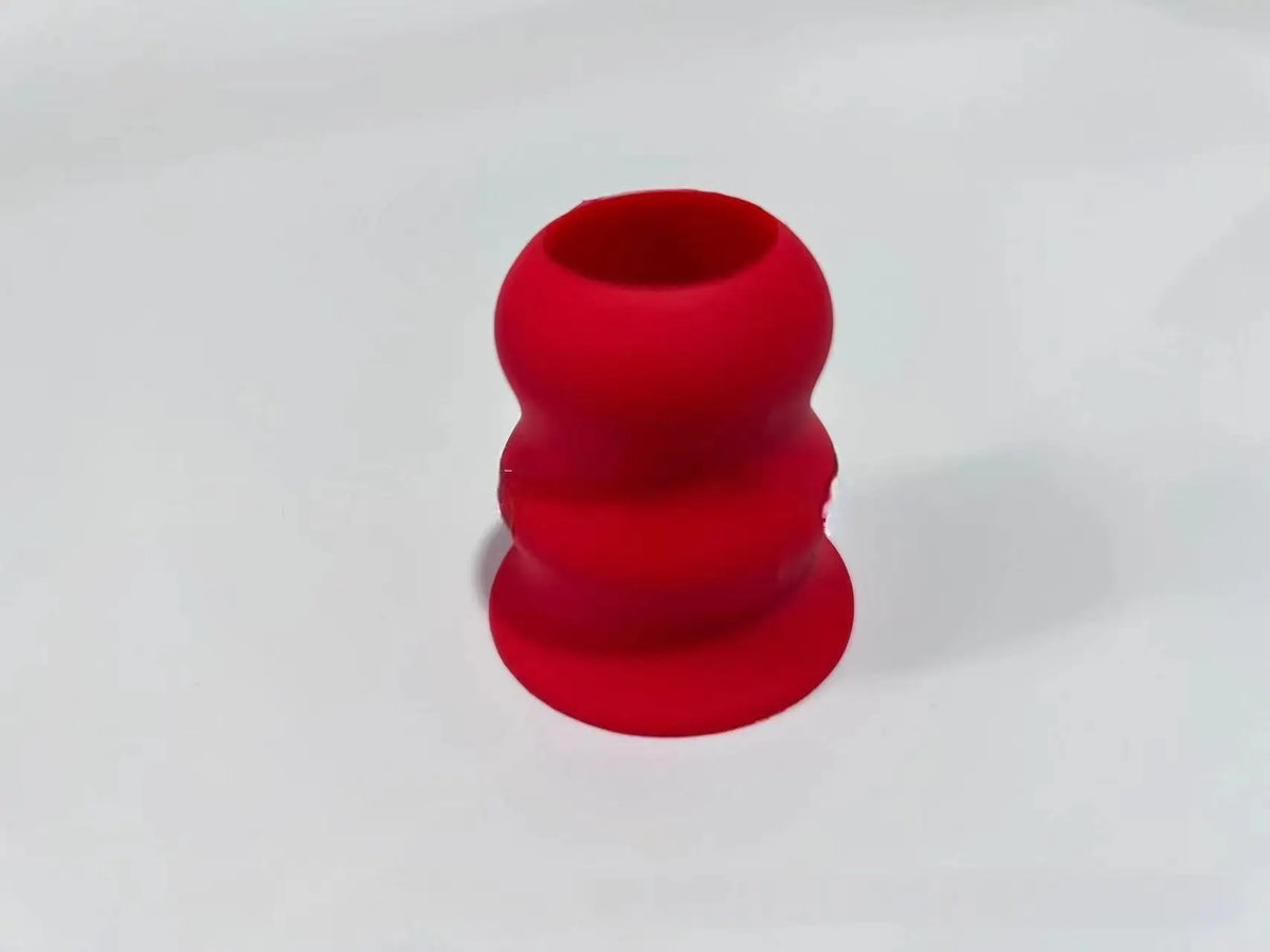 A set of three red silicone grips or knobs designed for baseball bat handles.