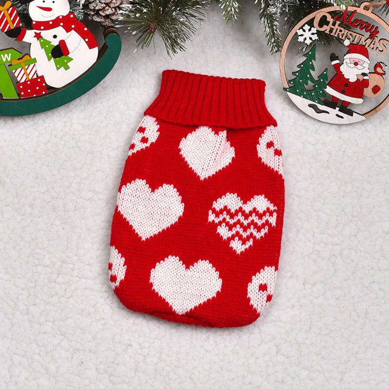 A red knitted sweater with white heart patterns and a ribbed collar, displayed on a white background.