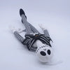 A plush toy of a cartoon skeleton dog wearing striped leggings and a black bow.