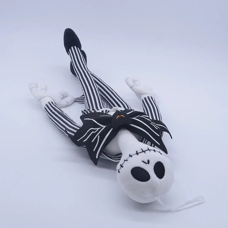 A plush toy of a cartoon skeleton dog wearing striped leggings and a black bow.