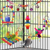 A parrot cage filled with natural wooden swing and chewing toys, including colorful chains and hanging elements.